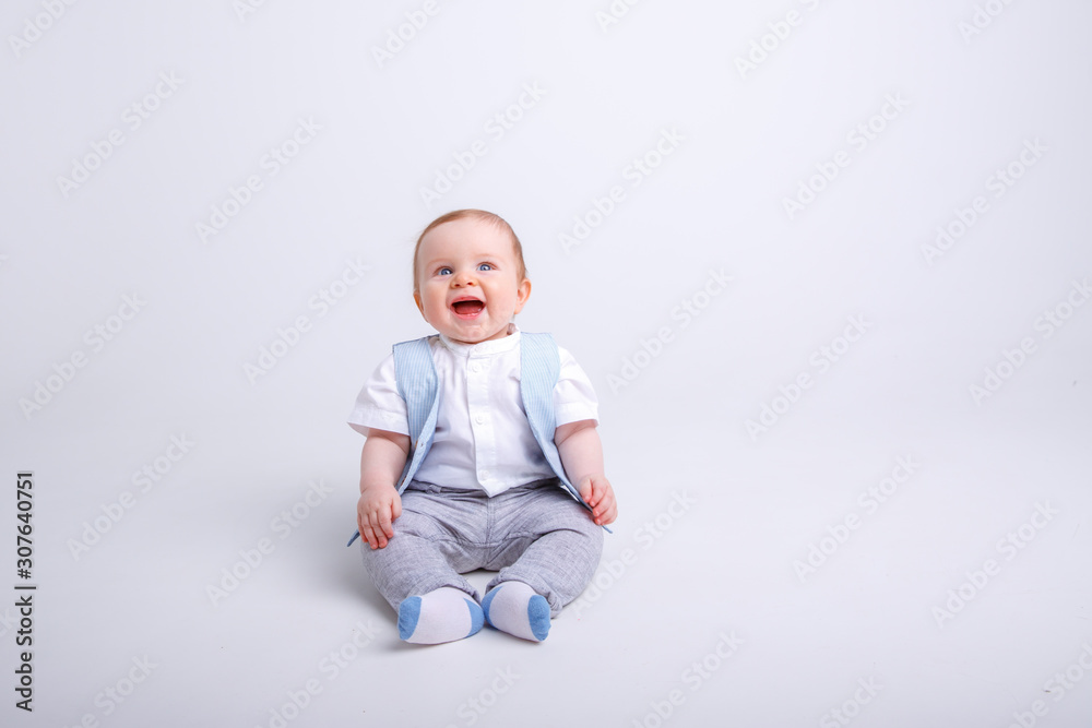 baby boy sitting on a white background baby boy sitting on a white background