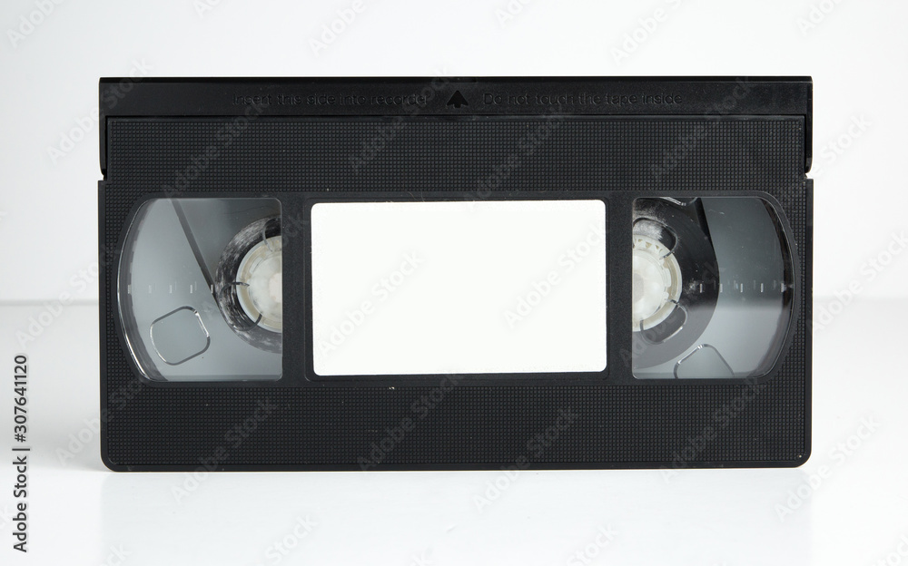 an Old retro vhs tape with a blank label for mock up, typography or graphics isolated on a white background. nostalgic 1980s music video cassette. obsolete media format.
