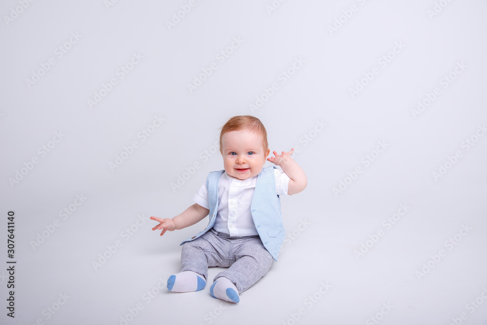 baby boy sitting on a white background baby boy sitting on a white background
