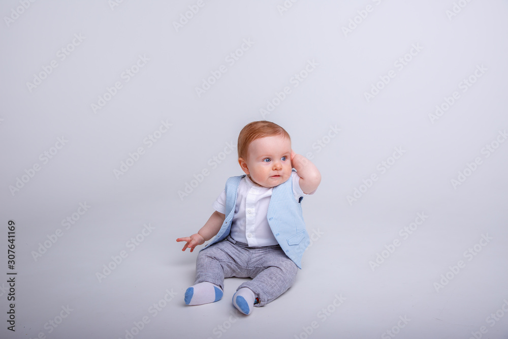 baby boy sitting on a white background baby boy sitting on a white background
