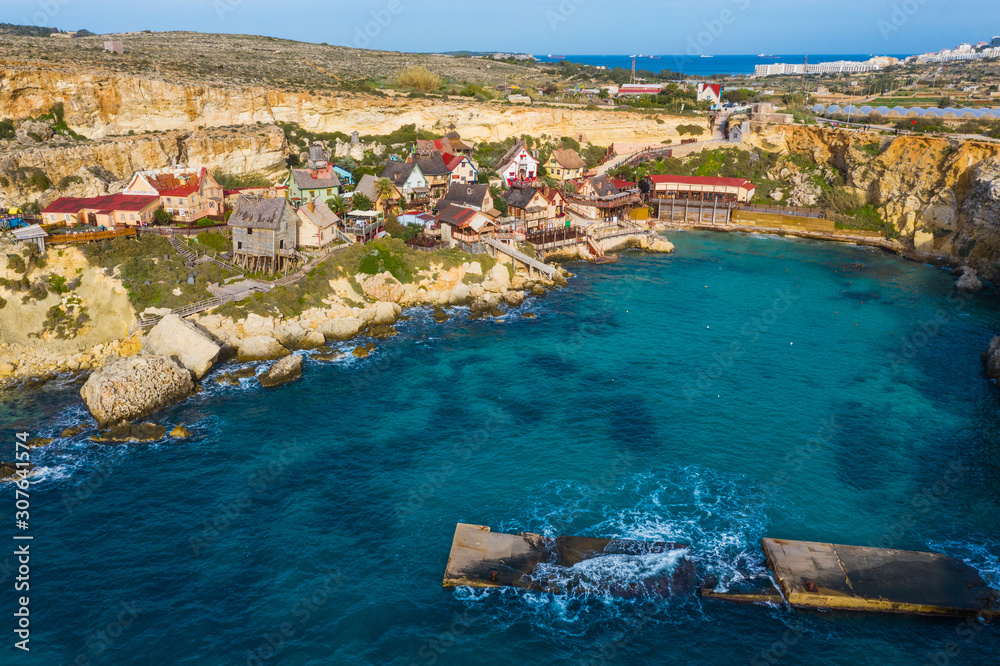 Top view of famous tourist attraction Popeye village, also known as Sweethaven village. Sunny day, blue sea. Mellieha city. Malta country