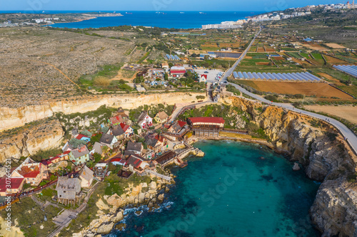 Top view of famous tourist attraction Popeye village, also known as Sweethaven village. Sunny day, blue sea. Mellieha city. Malta  photo