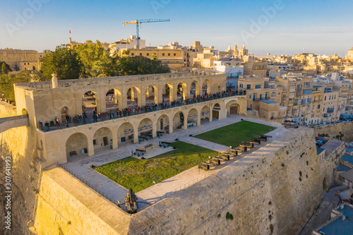 The Upper Barrakka Gardens, sunset sky. Aerial view, evening, people. Valletta city. Malta