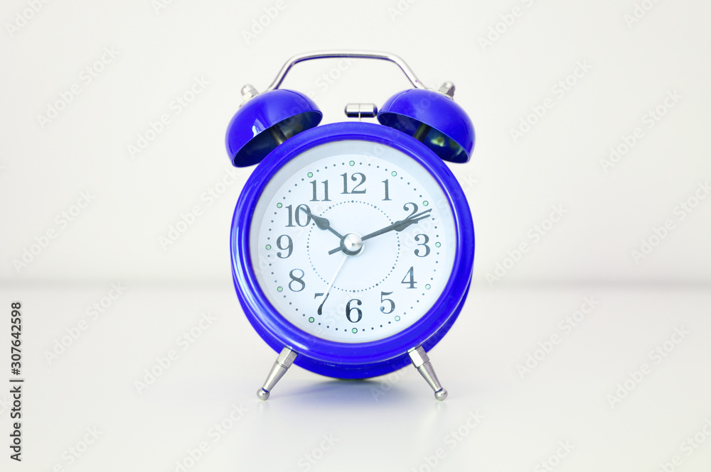 blue round analog alarm clock on white background. time 10:10. classic blue color 2020 blue round analog alarm clock on white background. time 10:10. classic blue color 2020