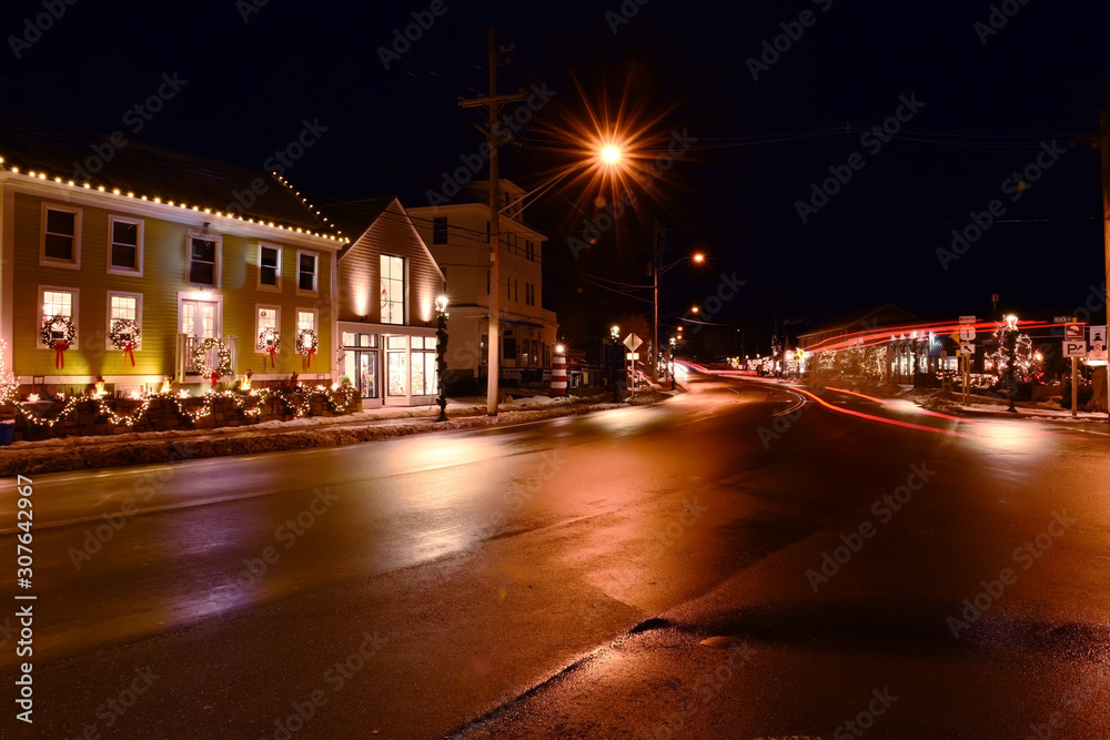 Streets of a small night city on the eve of Christmas and New Year holidays. American town on the ocean coast. USA. Maine