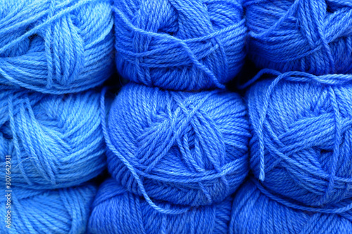 rows of bright skeins of wool yarn for knitting classic blue. color 2020