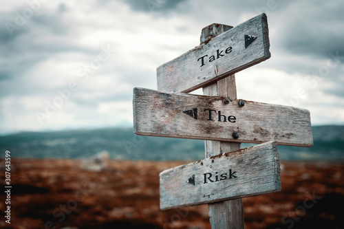 Take the risk signpost outdoors in nature. Lifestyle and business concept.