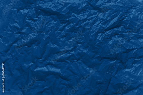 Abstract background in blue. Crumpled plastic surface.