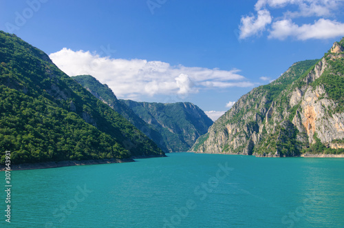 Aerial photo of Piva Lake in Montenegro. Road above Piva Lake (Pivsko Jezero). Montenegro, Pluzine, Lake of Piva, Mratinje Dam. © Della_Liner