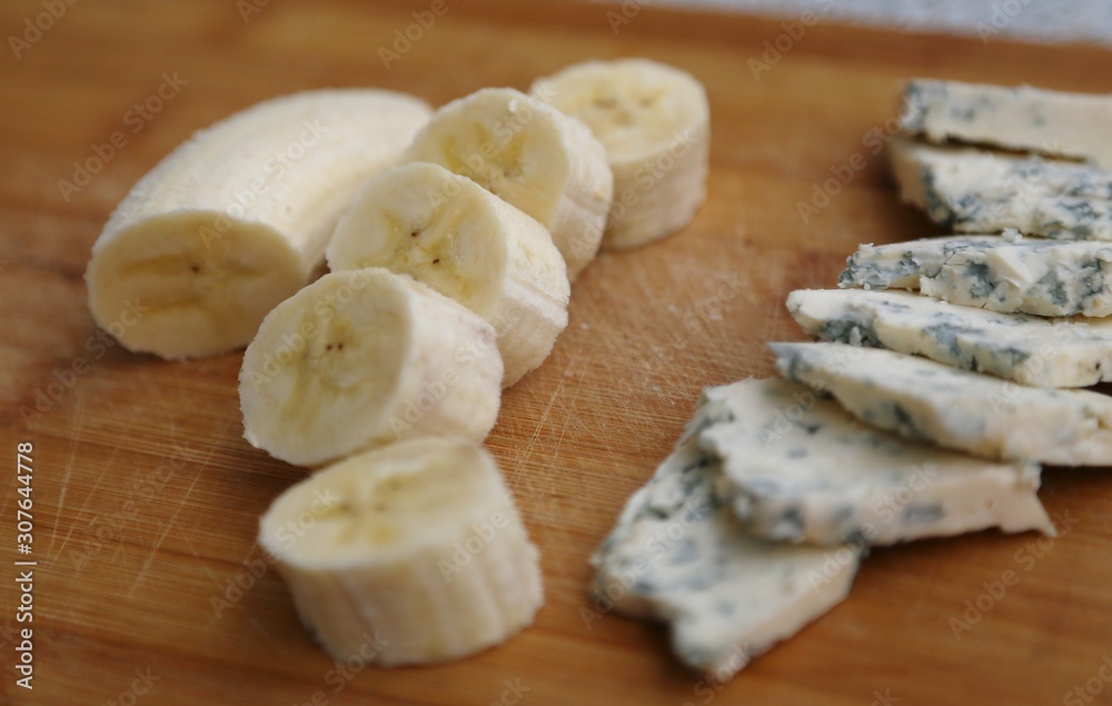 Cut cheese with mold and skin-free banana pieces ready to eat. Cut cheese with mold and skin-free banana pieces ready to eat.