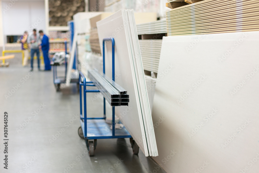 Trolley in a hardware store loaded with construction materials. Repair and construction concept Trolley in a hardware store loaded with construction materials. Repair and construction concept
