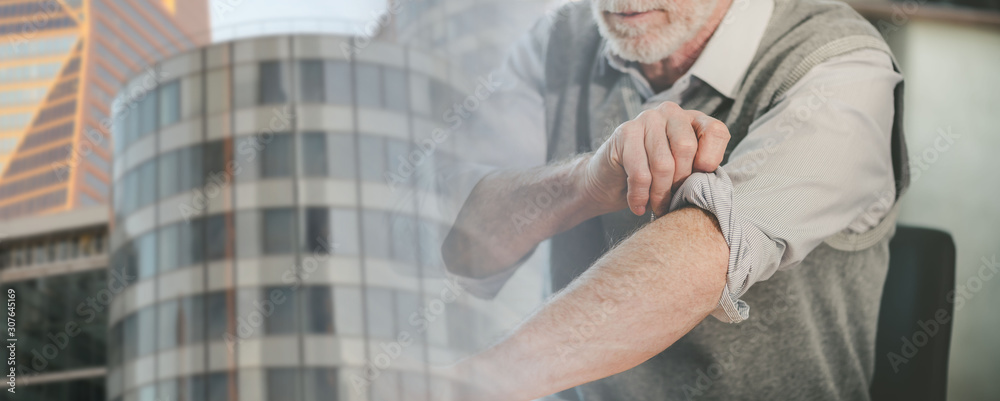 Businessman rolling up his sleeves; panoramic banner; multiple exposure