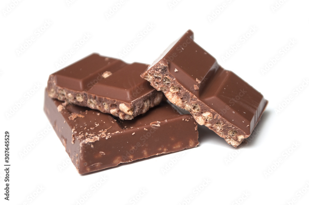 closeup of milk puffed rice chocolate blocks on white background closeup of milk puffed rice chocolate blocks on white background