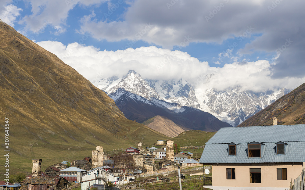 Ushguli  village on a background of mountains and snow-capped peaks in Svaneti in the mountainous part of Georgia