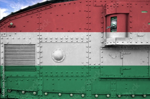 Hungary flag depicted on side part of military armored tank closeup. Army forces conceptual background photo