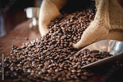 Obraz na plátně coffee beans in a sack on  dark table, top view