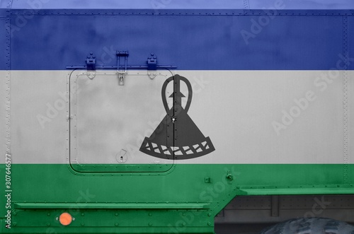 Lesotho flag depicted on side part of military armored truck closeup. Army forces conceptual background