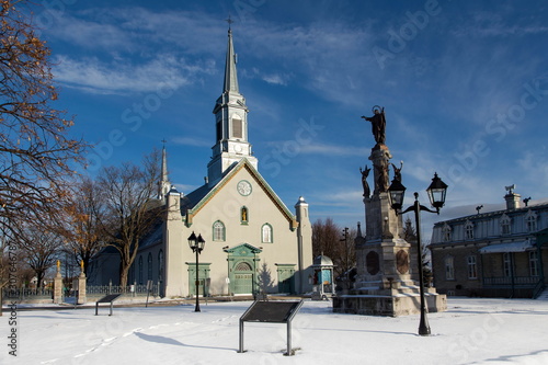 Town square with large 1816 neoclassical St-Augustin Church, patrimonial presbytery and statue on stone pedestal, Saint-Augustin-de-Desmaures, Quebec, Canada