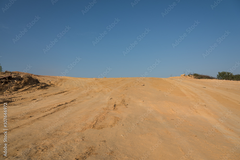 Yellow sandy slope pavement with sky landscape