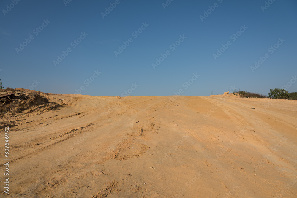 Yellow sandy slope pavement with sky landscape Yellow sandy slope pavement with sky landscape