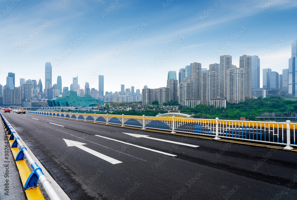 Expressway in front of the city skyline, Chongqing, China.