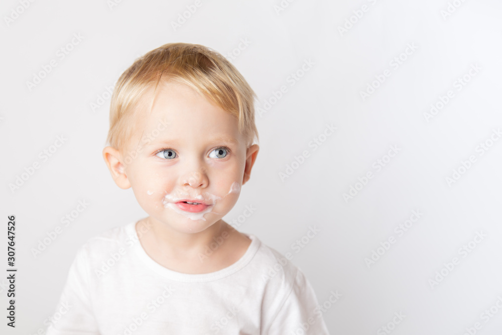 Portrait of fair-haired boy with chocolate on his face isolated on white. Portrait of fair-haired boy with chocolate on his face isolated on white.