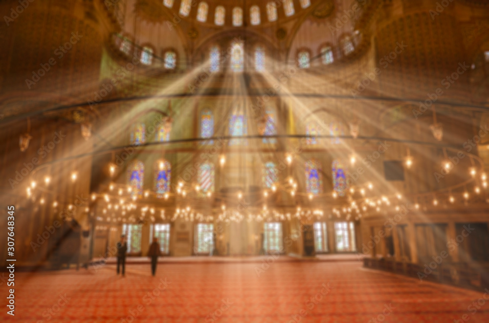 Out of focus or blurry image of a mosque interior.