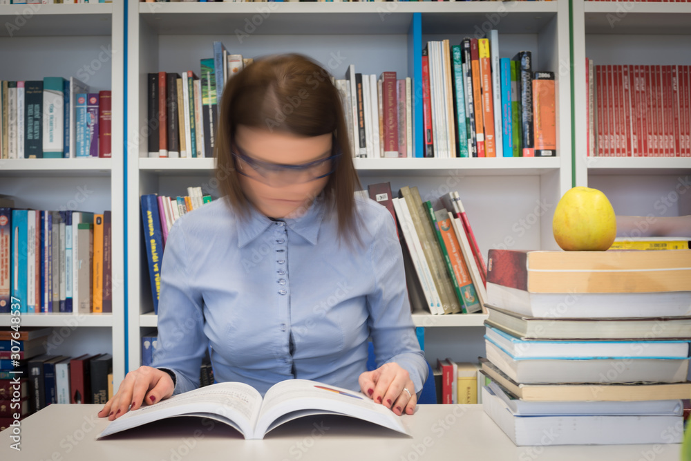 Girl in library posing, reading and studying Girl in library posing, reading and studying