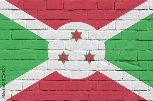 Burundi flag depicted in paint colors on old brick wall. Textured banner on big brick wall masonry background photo