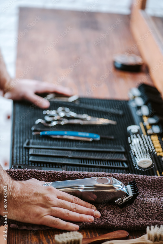 cropped view of barber near hairdressing equipment