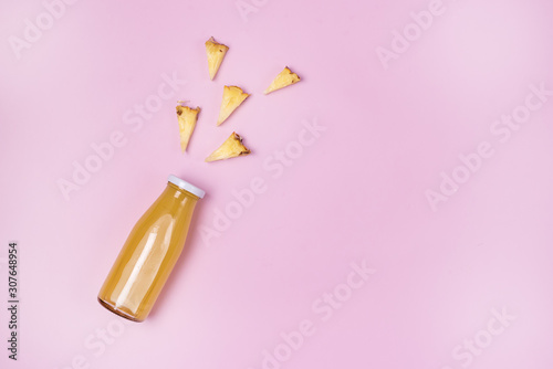 Glass Bottle of Fresh Tasty Pineapple Juice on Pink Background Top View Flat Lay Minimal Drink Concept Healthy Diet Detox Beverage