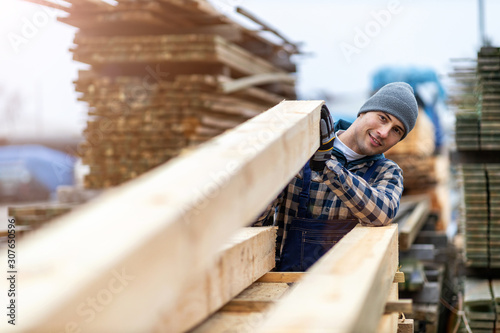 Young male worker in timber warehouse  photo