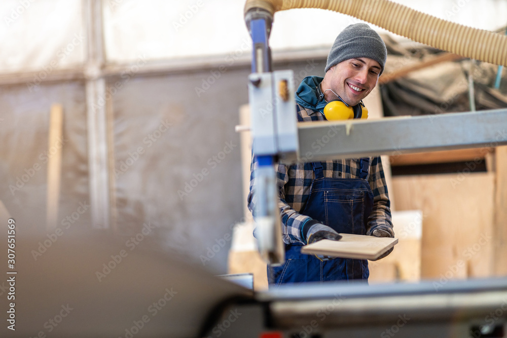 Young male worker in timber warehouse Young male worker in timber warehouse