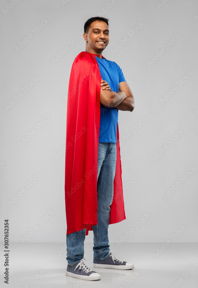 Fototapeta premium super power and people concept - happy smiling indian man in red superhero cape with crossed arms over grey background
