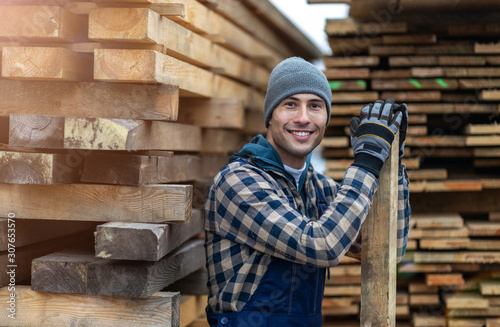 Young male worker in timber warehouse 