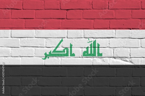 Iraq flag depicted in paint colors on old brick wall. Textured banner on big brick wall masonry background photo