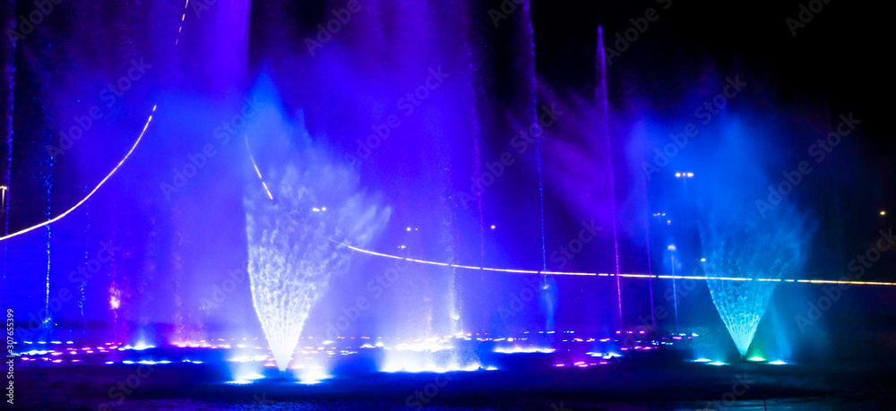 A dancing fountain of blue in the park