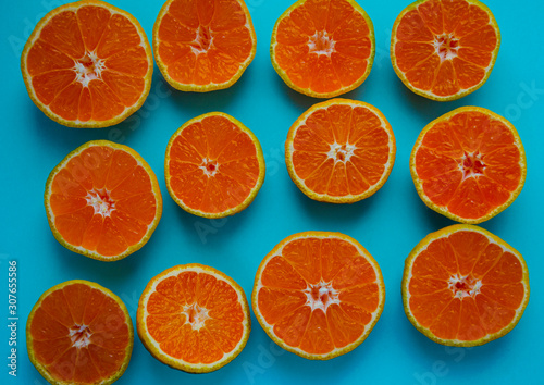 cut oranges on a blue background