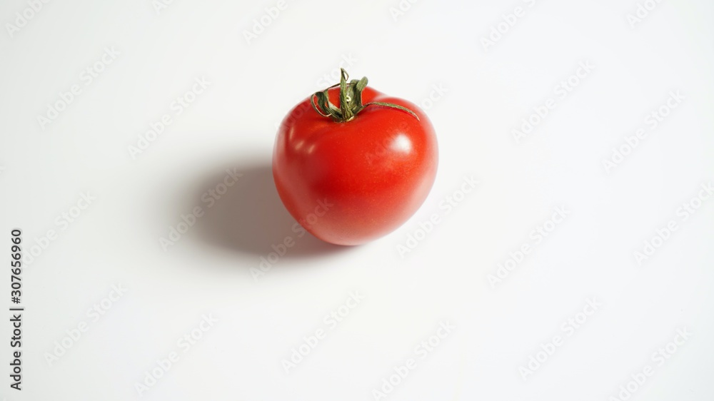 Red tomato on a white table