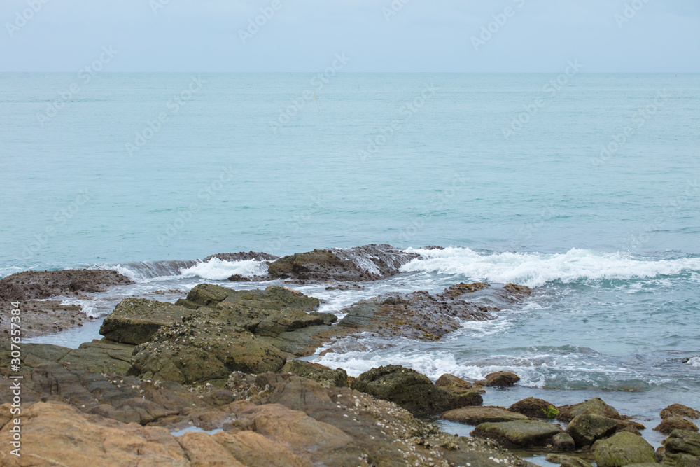 Stones and rocks on the coastline of the ocean after an outflow