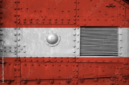 Austria flag depicted on side part of military armored tank closeup. Army forces conceptual background photo