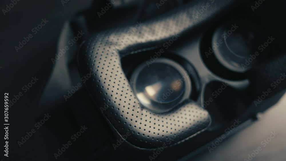 Close-up of virtual reality glasses VR hemlet lying on black table. Modern technologies concept. Close-up of virtual reality glasses VR hemlet lying on black table. Modern technologies concept.