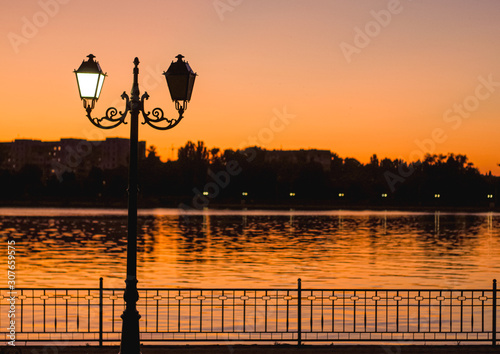 Intense orange sunset postcard from Chisinau with yin yang street lamp at Valea Morilor