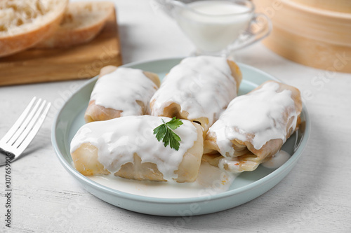 Delicious cabbage rolls served on white wooden table