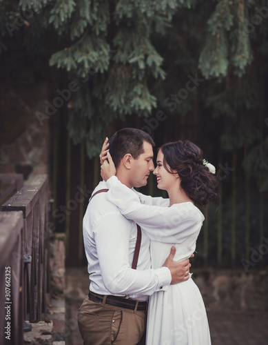 Beautiful young wedding couple hugging. Bride and groom in boho style