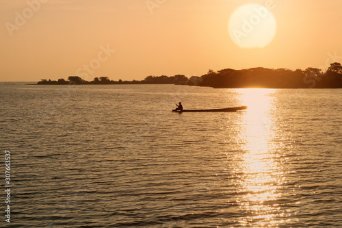 Asian fishermen on boat in the morning sun background