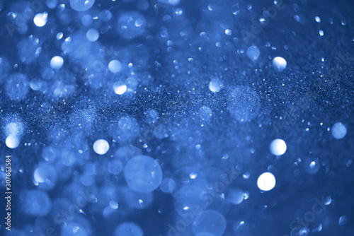 Holiday abstract texture. Christmas card with copy space. ?lassic blue background bokeh, defocused lights.