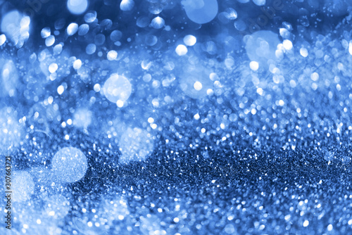 Holiday abstract texture. Christmas card with copy space. ?lassic blue background bokeh, defocused lights.