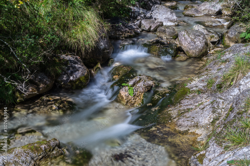 Tiny waterfalls at the Val Vertova torrent Lombardy near Bergamo in Italy Tiny waterfalls at the Val Vertova torrent Lombardy near Bergamo in Italy