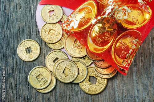 Close up topview coins spread out from red envelope , chinese new year decotation concept. photo